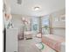 bedroom with white furniture, floral accents, soft rug, and lots of light at 18219 Ramble On Way, Land O Lakes, FL 34638