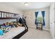 bedroom with bunk beds, lots of stuffed animals, window with blue curtains at 18219 Ramble On Way, Land O Lakes, FL 34638