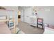 bedroom with white furniture, carpeted floor and view into the bathroom at 18219 Ramble On Way, Land O Lakes, FL 34638