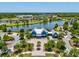 Aerial view of the community clubhouse overlooking a scenic lake, enhancing the luxurious appeal at 18219 Ramble On Way, Land O Lakes, FL 34638