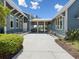 Side view of the exterior of the blue clubhouse and patio, showcasing bike storage and community amenities at 18219 Ramble On Way, Land O Lakes, FL 34638