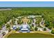 A scenic aerial view of the community clubhouse, showcasing its architectural design and surrounding landscape at 18219 Ramble On Way, Land O Lakes, FL 34638