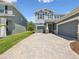 Charming two-story home with a three-car garage and paver driveway at 18219 Ramble On Way, Land O Lakes, FL 34638