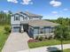 Attractive two-story home with blue siding, dark shutters, and a three-car garage at 18219 Ramble On Way, Land O Lakes, FL 34638