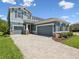 Beautiful two-story home featuring a paver driveway and well-maintained landscaping at 18219 Ramble On Way, Land O Lakes, FL 34638