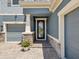 Charming home exterior showcasing a beautifully paved walkway leading to a stylish front door at 18219 Ramble On Way, Land O Lakes, FL 34638
