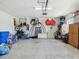 Garage with epoxy flooring with plenty of storage space for bikes and other outdoor equipment at 18219 Ramble On Way, Land O Lakes, FL 34638