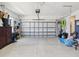 A spacious and well-lit garage, complete with epoxy flooring and a functional garage door at 18219 Ramble On Way, Land O Lakes, FL 34638
