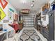 Neat garage with work bench, wall decorations, tool chests, and shelving at 18219 Ramble On Way, Land O Lakes, FL 34638