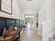Hallway with stylish decor, leading to a bright living space and staircase at 18219 Ramble On Way, Land O Lakes, FL 34638