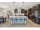 Modern kitchen with a large center island, stainless steel appliances, and stylish pendant lighting at 18219 Ramble On Way, Land O Lakes, FL 34638