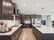 A modern kitchen with a spacious island, stainless steel appliances, and dark cabinetry at 18219 Ramble On Way, Land O Lakes, FL 34638