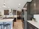 Modern kitchen with stainless steel appliances, stone countertops and dark wood cabinets at 18219 Ramble On Way, Land O Lakes, FL 34638