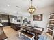 A well-lit kitchen and dining space with rustic wooden furniture and stylish decor at 18219 Ramble On Way, Land O Lakes, FL 34638