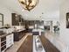 An open-concept kitchen and dining area with modern lighting and sleek cabinetry at 18219 Ramble On Way, Land O Lakes, FL 34638