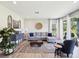 Bright living room featuring a comfortable sectional sofa and access to the outdoors at 18219 Ramble On Way, Land O Lakes, FL 34638