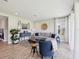 Bright living room featuring a comfortable sectional sofa, chairs and wood-look tile flooring at 18219 Ramble On Way, Land O Lakes, FL 34638