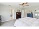 Spacious main bedroom featuring a cozy fireplace, neutral tones, and adjoining bathroom access at 18219 Ramble On Way, Land O Lakes, FL 34638