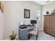 A functional office space with a desk, chair, and classic wooden cabinet at 18219 Ramble On Way, Land O Lakes, FL 34638