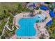 An aerial shot of the community pool with a slide and plenty of lounge chairs at 19407 Sweet Grass Way, Lutz, FL 33558