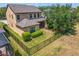 Aerial view of home and fenced backyard features a lush, manicured lawn at 19407 Sweet Grass Way, Lutz, FL 33558