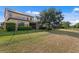 Spacious backyard features a metal fence, manicured lawn, and shade trees at 19407 Sweet Grass Way, Lutz, FL 33558