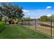 The backyard features a well-kept lawn, metal fencing and lush landscaping at 19407 Sweet Grass Way, Lutz, FL 33558