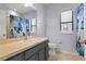 Bathroom with blue cabinets, butterfly shower curtain and neutral tile flooring at 19407 Sweet Grass Way, Lutz, FL 33558