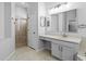 Well-lit bathroom showcasing a shower and vanity with mirror, offering style and functionality at 19407 Sweet Grass Way, Lutz, FL 33558