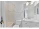 A bathroom featuring a shower-tub, vanity with sink, toilet and neutral-toned tile at 19407 Sweet Grass Way, Lutz, FL 33558