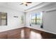 Bright bedroom featuring hardwood floors, a ceiling fan, and natural light from large windows at 19407 Sweet Grass Way, Lutz, FL 33558