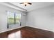 Clean bedroom showcasing hardwood floors and a window that floods the room with natural light at 19407 Sweet Grass Way, Lutz, FL 33558
