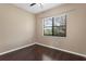 Empty bedroom showcasing wood floors and natural light at 19407 Sweet Grass Way, Lutz, FL 33558