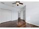 A well-lit bedroom featuring hardwood floors, a ceiling fan, and a spacious closet at 19407 Sweet Grass Way, Lutz, FL 33558