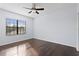 Bright and airy bedroom with hardwood flooring, ceiling fan and large window at 19407 Sweet Grass Way, Lutz, FL 33558