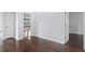 Hardwood-floored bedroom shows adjacent areas in open floor plan at 19407 Sweet Grass Way, Lutz, FL 33558