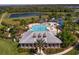 The aerial shot shows the clubhouse with a pool for residents to enjoy at 19407 Sweet Grass Way, Lutz, FL 33558