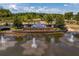 Scenic view of the Stonebrier community entrance with lush landscaping and serene fountains at 19407 Sweet Grass Way, Lutz, FL 33558