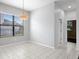 Bright dining area with tile flooring, a modern light fixture, and large windows at 19407 Sweet Grass Way, Lutz, FL 33558