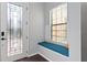 Charming entryway featuring a cozy window seat and decorative glass front door at 19407 Sweet Grass Way, Lutz, FL 33558