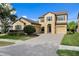 Inviting two-story home featuring a paver driveway and a convenient two-car garage at 19407 Sweet Grass Way, Lutz, FL 33558