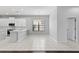 Bright kitchen with modern white cabinets and tile flooring adjoining the breakfast area at 19407 Sweet Grass Way, Lutz, FL 33558