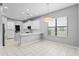 Bright eat-in kitchen featuring white cabinetry, stainless steel appliances, and pendant lighting at 19407 Sweet Grass Way, Lutz, FL 33558
