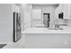 Clean kitchen showcasing stainless steel refrigerator and white quartz countertop at 19407 Sweet Grass Way, Lutz, FL 33558