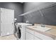 Laundry room with washer, dryer, shelving, and sink at 19407 Sweet Grass Way, Lutz, FL 33558