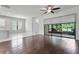 Spacious living room with hardwood floors and a view of the kitchen and patio at 19407 Sweet Grass Way, Lutz, FL 33558