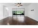 Bright living room featuring hardwood floors, a ceiling fan, and a sliding glass door to the outdoors at 19407 Sweet Grass Way, Lutz, FL 33558