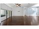 Bright and airy living room featuring sleek hardwood floors and sliding glass doors to the outside at 19407 Sweet Grass Way, Lutz, FL 33558