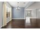 Elegant living room featuring hardwood floors, large windows, and neutral wall color at 19407 Sweet Grass Way, Lutz, FL 33558