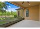 The screened patio offers beautiful views of the manicured lawn and lush landscaping at 19407 Sweet Grass Way, Lutz, FL 33558